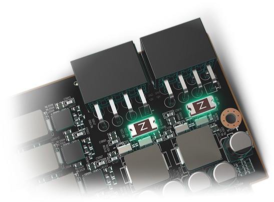 Una sección de una placa de circuito negro con varios componentes electrónicos, incluyendo dos chips negros grandes con disipadores de calor y varios chips más pequeños y condensadores plateados. Dos componentes más pequeños están marcados con una Z verde brillante.